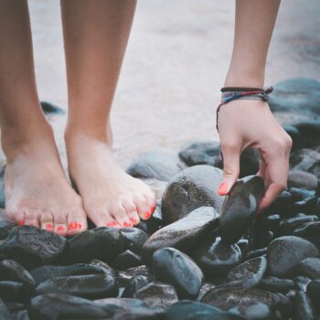 beach feet hand pebbles sand 1836461
